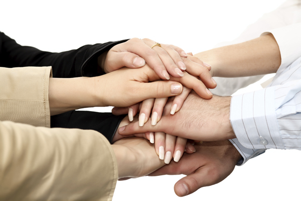 Closeup of many Hands on top of each other. over white background